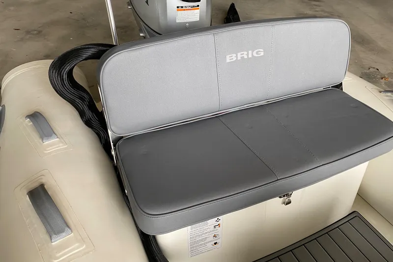 Slide: The Image of 2022 Brig Falcon 330 boat with gray seating and backrest. - 9