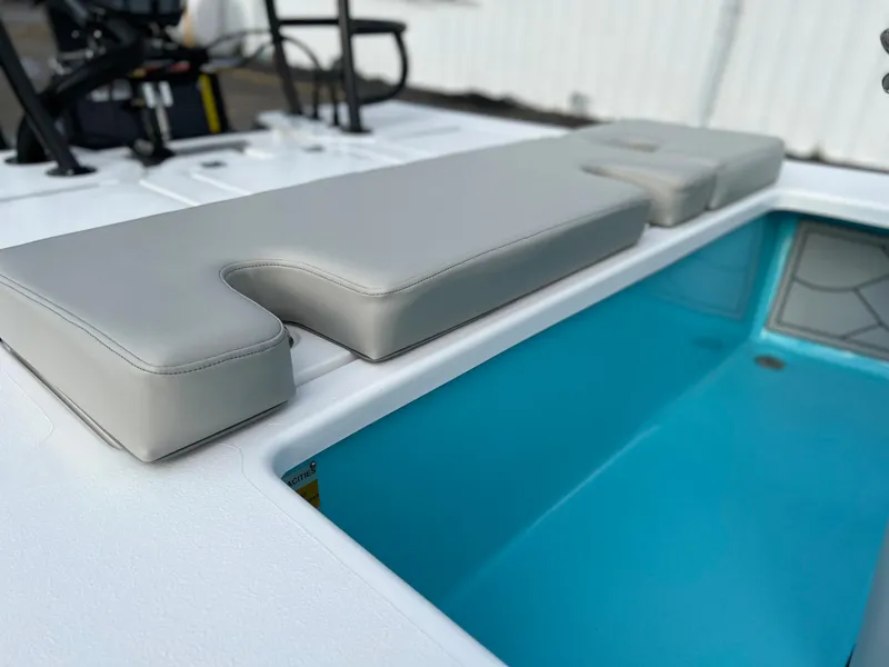 Slide: The Image of Xplor X7 2022 boat with cushioned seating and blue storage compartment. - 7