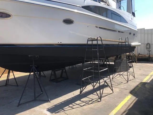 Slide: The Image of 2002 Carver 396 Aft Cabin MY yacht on stands in a boatyard. - 15