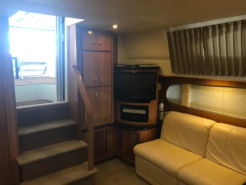 Slide: The Image of Interior of 2002 Carver 396 Aft Cabin MY with sofa, TV, and stairs. - 25