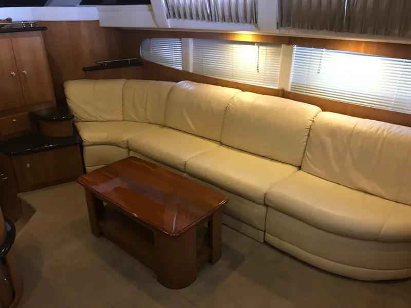 Slide: The Image of Luxurious interior of 2002 Carver 396 Aft Cabin MY with cream leather sofa and wooden table. - 27