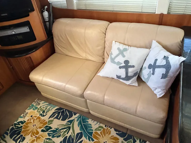 Slide: The Image of Beige leather sofa with anchor pillows in 2002 Carver 396 Aft Cabin MY yacht interior. - 46