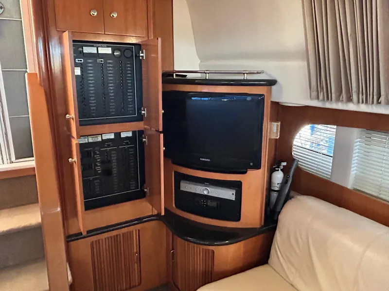 Slide: The Image of Interior of 2002 Carver 396 Aft Cabin MY with TV and control panels. - 48