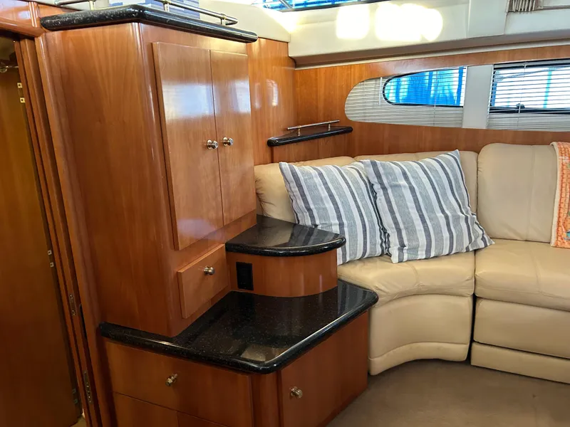 Slide: The Image of 2002 Carver 396 Aft Cabin MY interior with wood cabinetry and beige seating. - 49