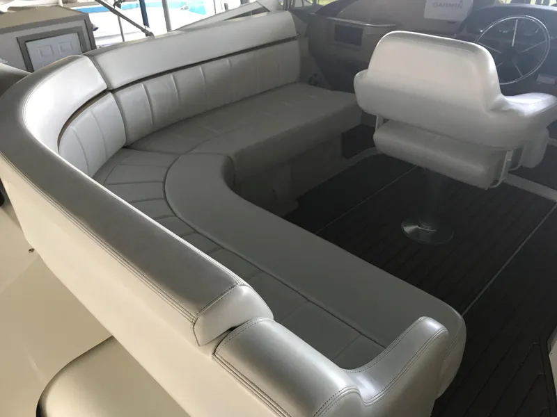 Slide: The Image of 2002 Carver 396 Aft Cabin MY interior with white seating and helm chair. - 21