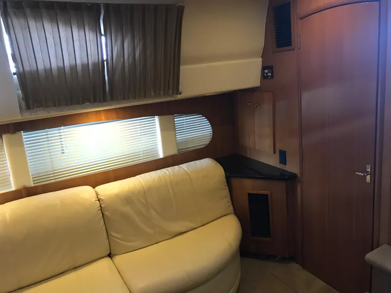 Slide: The Image of Interior of 2002 Carver 396 Aft Cabin MY with beige sofa and wooden cabinetry. - 26