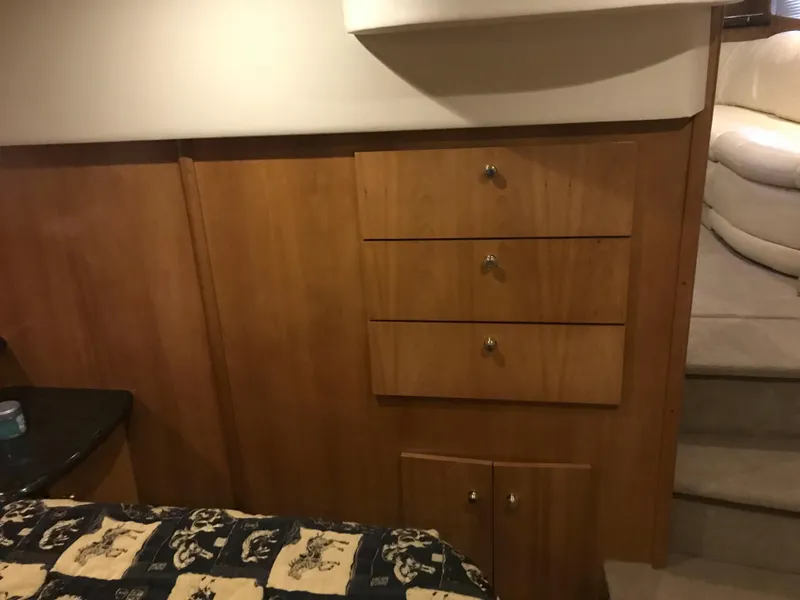 Slide: The Image of Interior of 2002 Carver 396 Aft Cabin MY with wooden cabinetry and patterned bedding. - 38