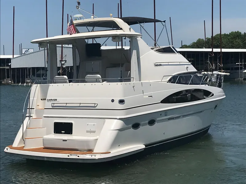 Slide: The Image of 2002 Carver 396 Aft Cabin MY yacht docked in marina, rear view. - 8