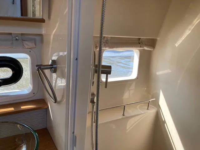 Slide: The Image of Interior of 2019 Sea Ray 350 Sundancer yacht bathroom with windows and shower. - 16