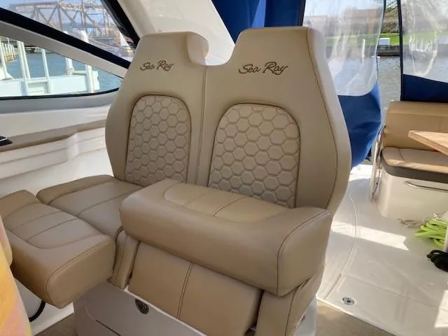Slide: The Image of 2019 Sea Ray 350 Sundancer interior with beige leather seats and honeycomb pattern. - 18