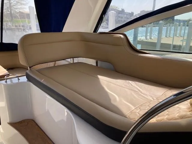 Slide: The Image of 2019 Sea Ray 350 Sundancer interior seating with beige upholstery. - 19