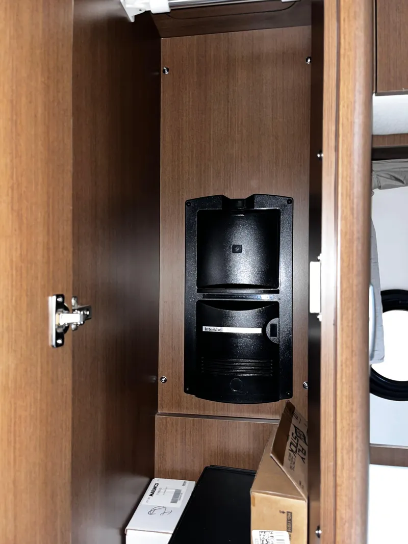 Slide: The Image of Cabinet interior on 2019 Sea Ray 350 Sundancer yacht with storage and built-in coffee maker. - 20