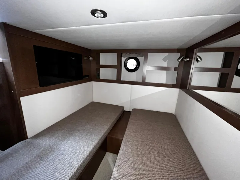 Slide: The Image of 2019 Sea Ray 350 Sundancer cabin interior with twin beds and modern design. - 22