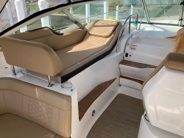 Slide: The Image of 2019 Sea Ray 350 Sundancer interior with beige leather seating and modern design. - 4