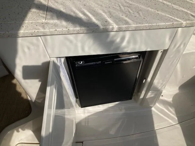 Slide: The Image of Built-in mini fridge on 2019 Sea Ray 350 Sundancer boat. - 6