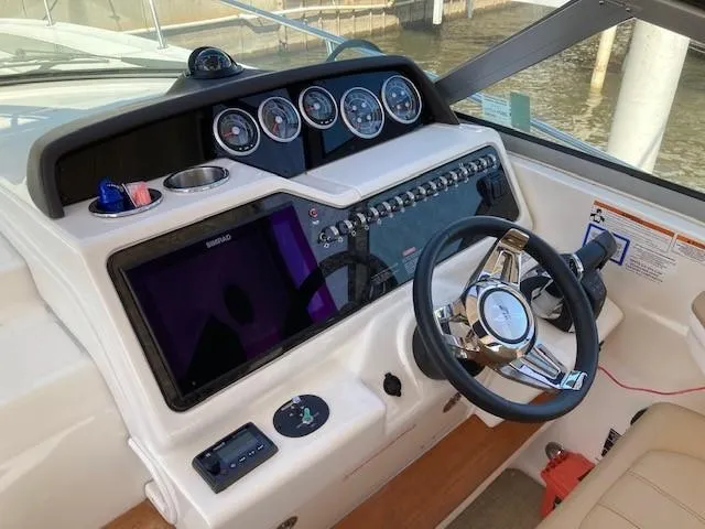 Slide: The Image of 2019 Sea Ray 350 Sundancer helm with modern controls and navigation system. - 7