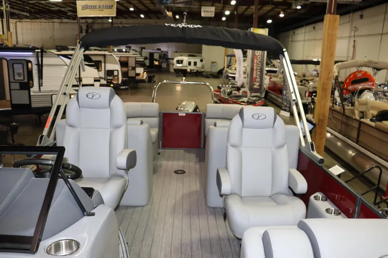Slide: The Image of Interior view of a Veranda VTX 22VLC pontoon boat with gray seating and a black canopy. - 2