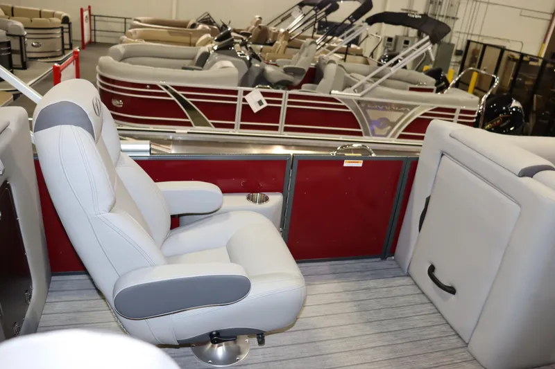 Slide: The Image of A luxurious seat on a Veranda VTX 22VLC pontoon boat, surrounded by other boats in the showroom. - 8