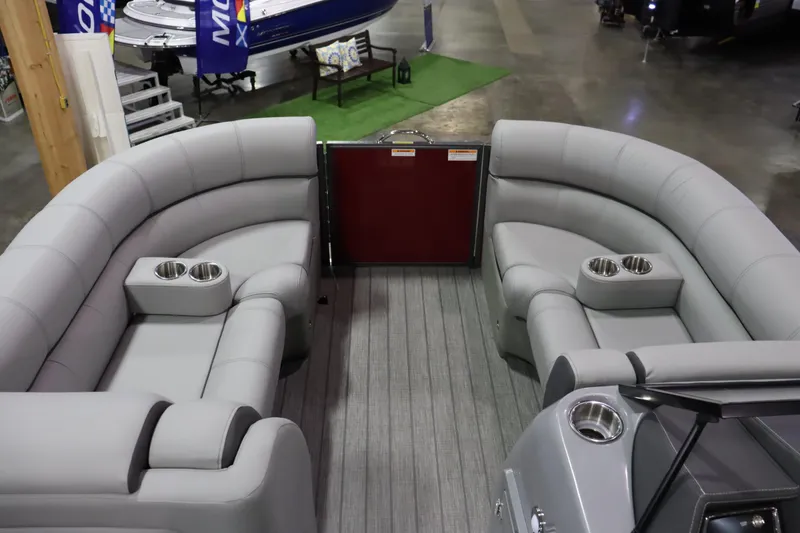 Slide: The Image of Interior of a 2022 Veranda VTX 22VLC with gray upholstered seating and cup holders. - 3