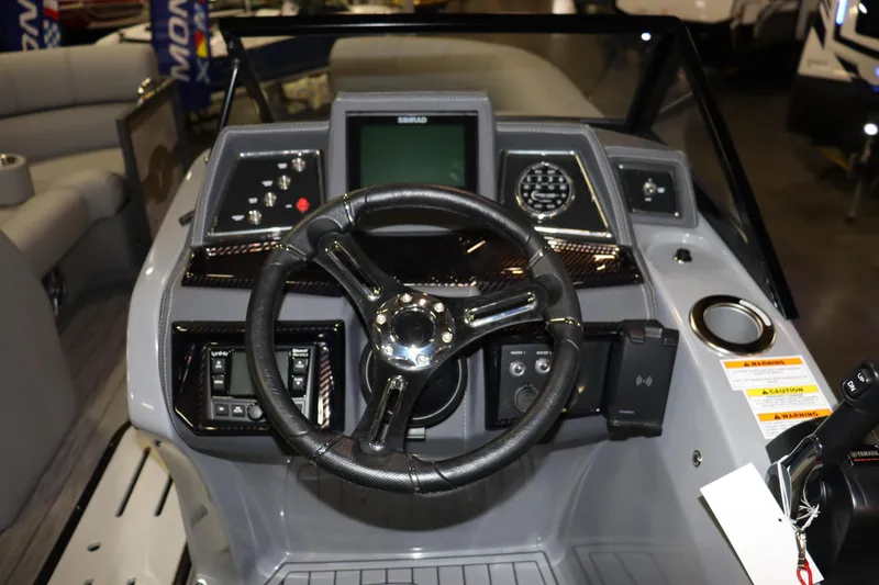 Slide: The Image of The image shows the helm of a 2022 Veranda VTX 22VLC boat with a modern steering wheel and instruments. - 7