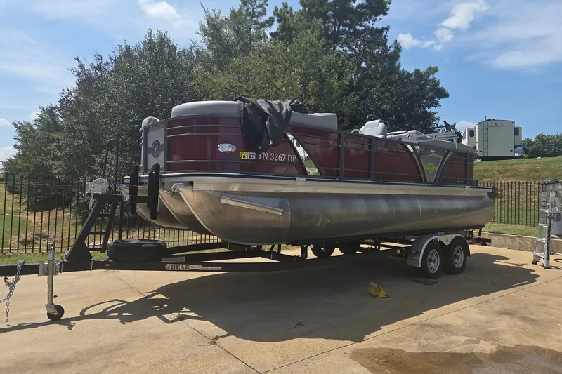 The Image of 2022 Veranda VTX 22VLC pontoon boat on trailer, parked outdoors on a sunny day. - 0