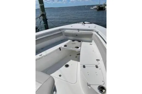 Slide: The Image of 2019 Sea Pro 239 Center Console boat docked by the water. - 29