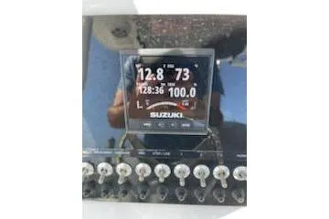 Slide: The Image of Close-up of 2019 Sea Pro 239 Center Console dashboard with Suzuki display and controls. - 32