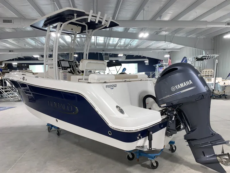 Slide: The Image of 2024 Robalo R222 Center Console boat with Yamaha outboard motor in showroom. - 1