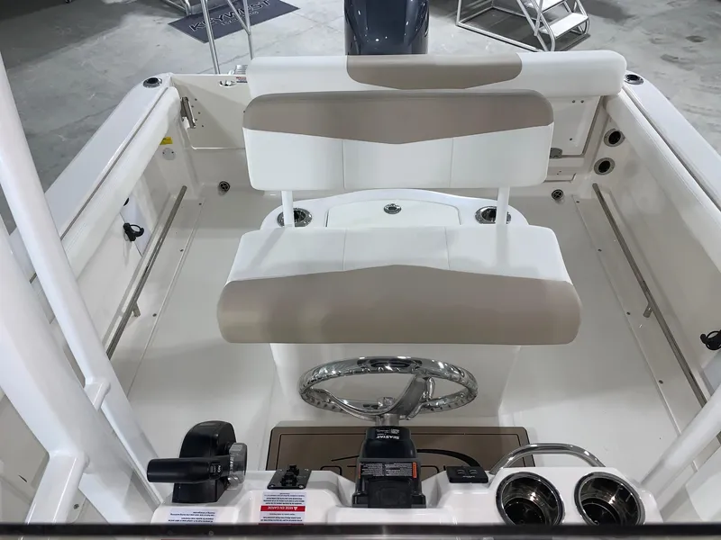 Slide: The Image of 2024 Robalo R222 Center Console boat interior with helm and seating. - 12