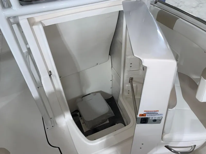 Slide: The Image of 2024 Robalo R222 Center Console boat interior with built-in storage compartment. - 14