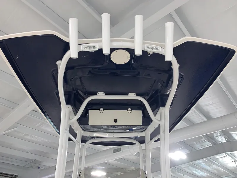 Slide: The Image of 2024 Robalo R222 Center Console T-top with rod holders. - 4