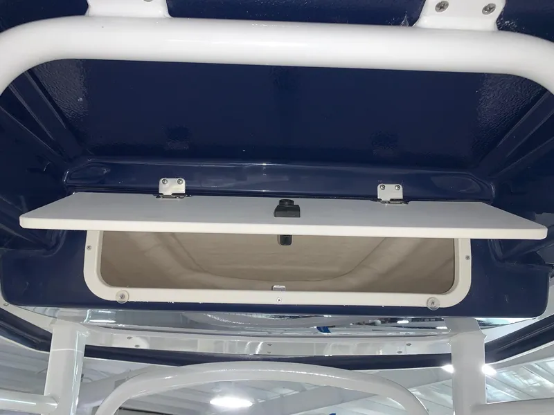Slide: The Image of 2024 Robalo R222 Center Console storage compartment with open hatch. - 9