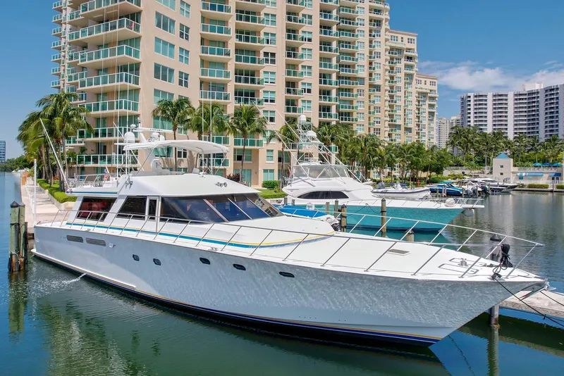 The Image of 1991 Jones-Goodell Yachtfish docked in a marina with high-rise buildings in the background. - 0
