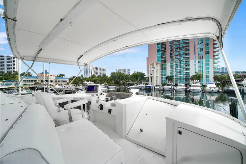Slide: The Image of 1991 Jones-Goodell Yachtfish interior view at marina with cityscape background. - 18