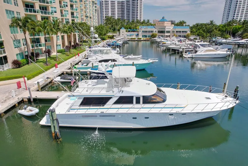 Slide: The Image of 1991 Jones-Goodell Yachtfish docked in a marina with luxury buildings. - 27