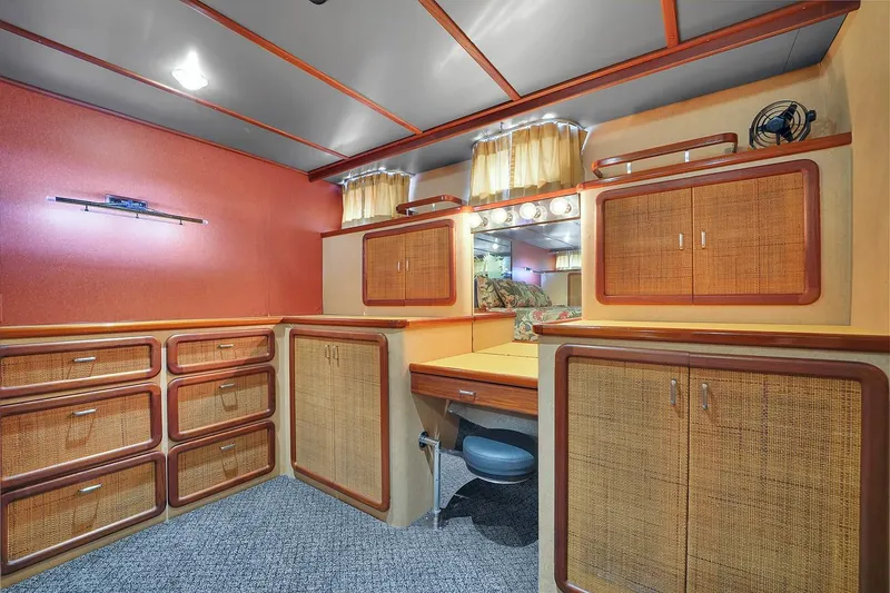 Slide: The Image of 1991 Jones-Goodell Yachtfish interior with wooden cabinets and vanity area. - 29