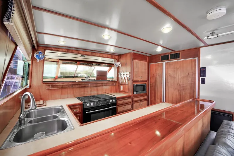 Slide: The Image of 1991 Jones-Goodell Yachtfish kitchen with modern appliances and wooden cabinetry. - 34