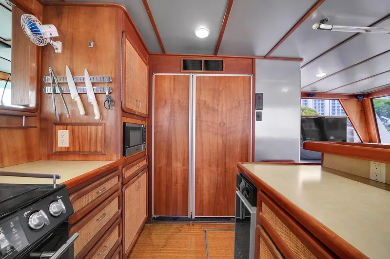 Slide: The Image of 1991 Jones-Goodell Yachtfish kitchen with wooden cabinetry and modern appliances. - 37