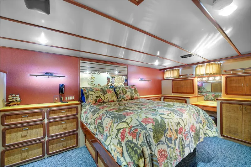 Slide: The Image of Luxurious bedroom interior of a 1991 Jones-Goodell Yachtfish with floral bedding and ample storage. - 46