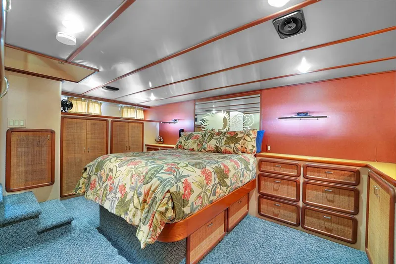Slide: The Image of Luxurious bedroom interior of a 1991 Jones-Goodell Yachtfish yacht with floral bedding. - 47