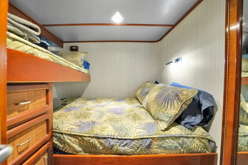 Slide: The Image of Cozy bedroom in a 1991 Jones-Goodell Yachtfish with bunk beds and tropical bedding. - 49