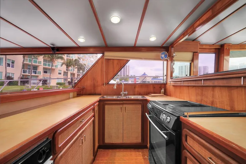 Slide: The Image of Interior kitchen of 1991 Jones-Goodell Yachtfish with wooden cabinetry and modern appliances. - 6