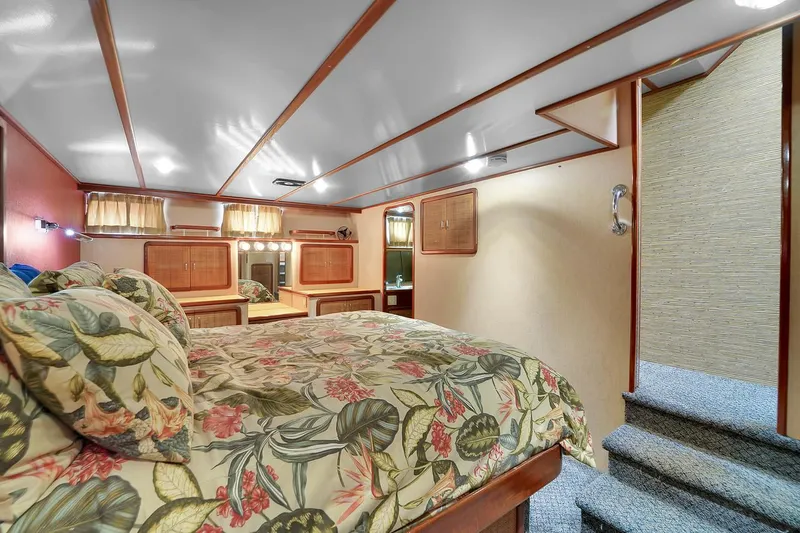 Slide: The Image of Luxurious bedroom interior of 1991 Jones-Goodell Yachtfish with floral bedding and wooden accents. - 7