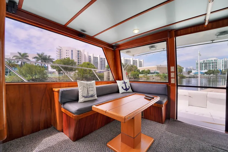 Slide: The Image of Interior of 1991 Jones-Goodell Yachtfish with waterfront view, cozy seating, and nautical decor. - 8
