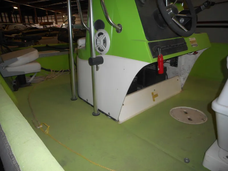 Slide: The Image of 1994 Hydra-Sports OSO Center Console boat interior with green and white design. - 11