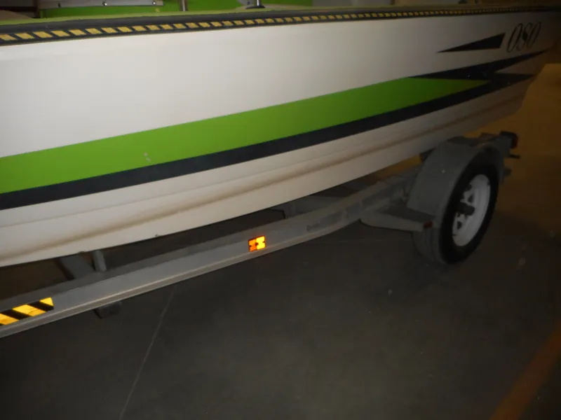 Slide: The Image of 1994 Hydra-Sports OSO Center Console boat on trailer, side view with green and black stripes. - 12