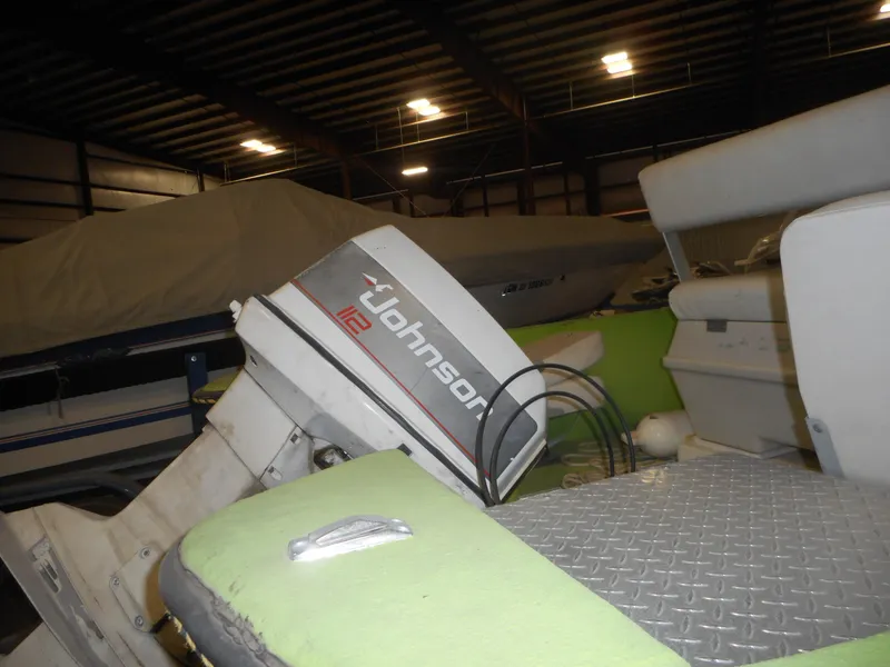 Slide: The Image of 1994 Hydra-Sports OSO Center Console boat with Johnson 112 outboard motor in storage. - 6