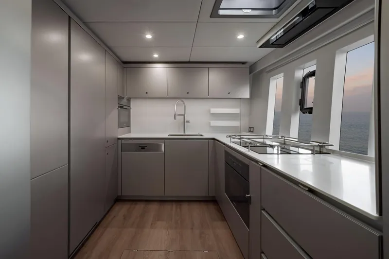 Slide: The Image of Modern kitchen interior on 2025 Sunreef 80 yacht, featuring sleek cabinetry and ocean view. - 49