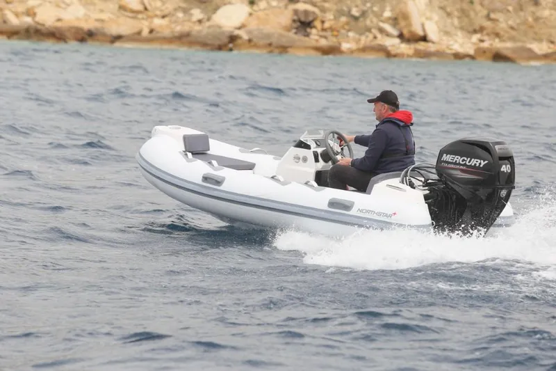Slide: The Image of 2021 Northstar Axis 3.1 boat with Mercury engine cruising on water. - 1