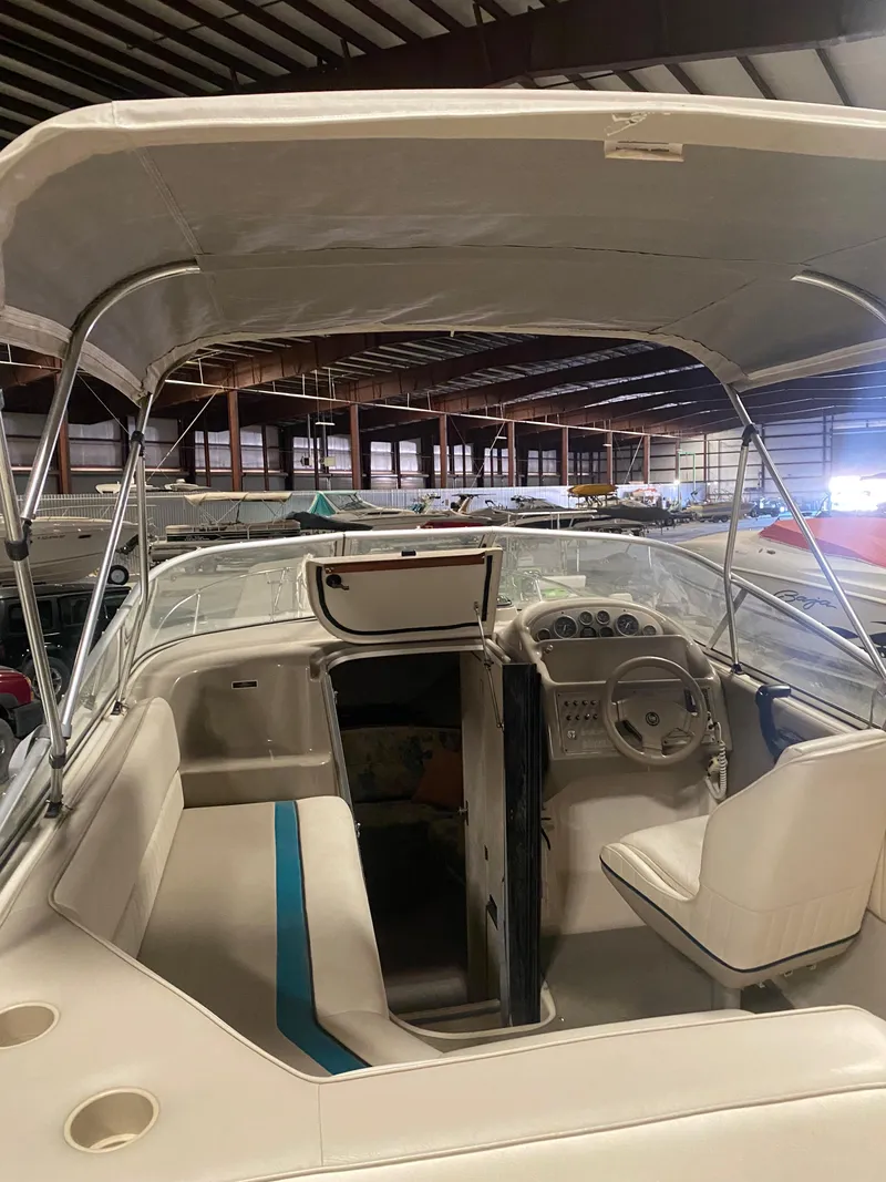 Slide: The Image of 1995 Bayliner Ciera boat interior with canopy in storage facility. - 18